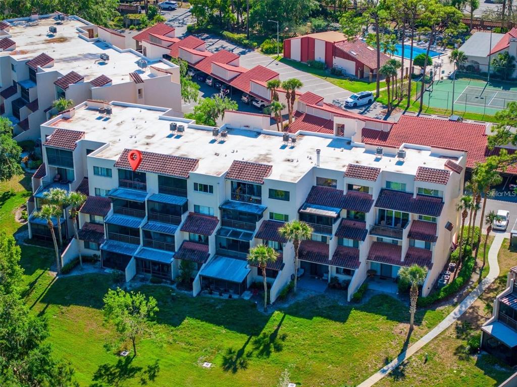 An exterior view of a building hallway featuring a white front door labeled 440 — 1162 CARMEL CIRCLE UNIT 440, CASSELBERRY, FL