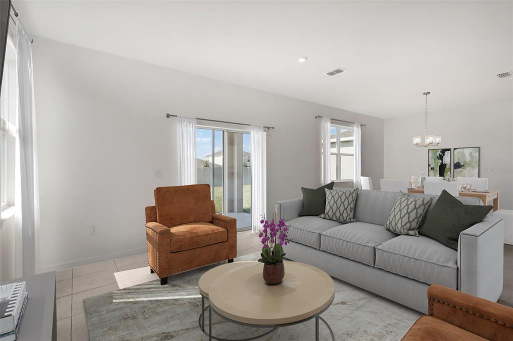 A living room features a grey sofa, two brown armchairs, and a sliding glass door — 777 CASTLEFORD AVENUE NE, PALM BAY, FL