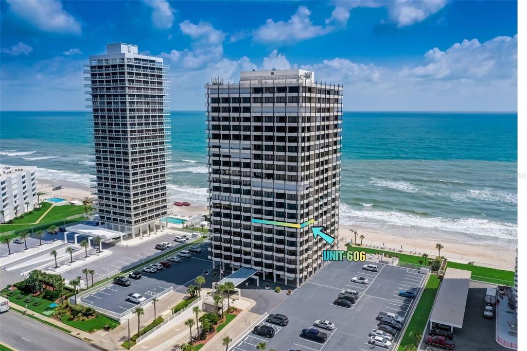 An aerial view shows two tall beachfront residential towers with a parking lot below — 2900 N ATLANTIC AVENUE UNIT 6060, DAYTONA BEACH, FL