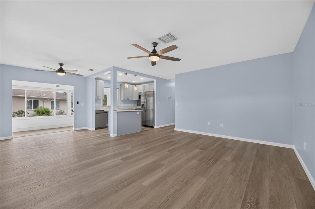 A kitchen with grey cabinets, stainless steel appliances, and light-colored countertops — 110 GLOUCESTER BOULEVARD UNIT 346, SUN CITY CENTER, FL