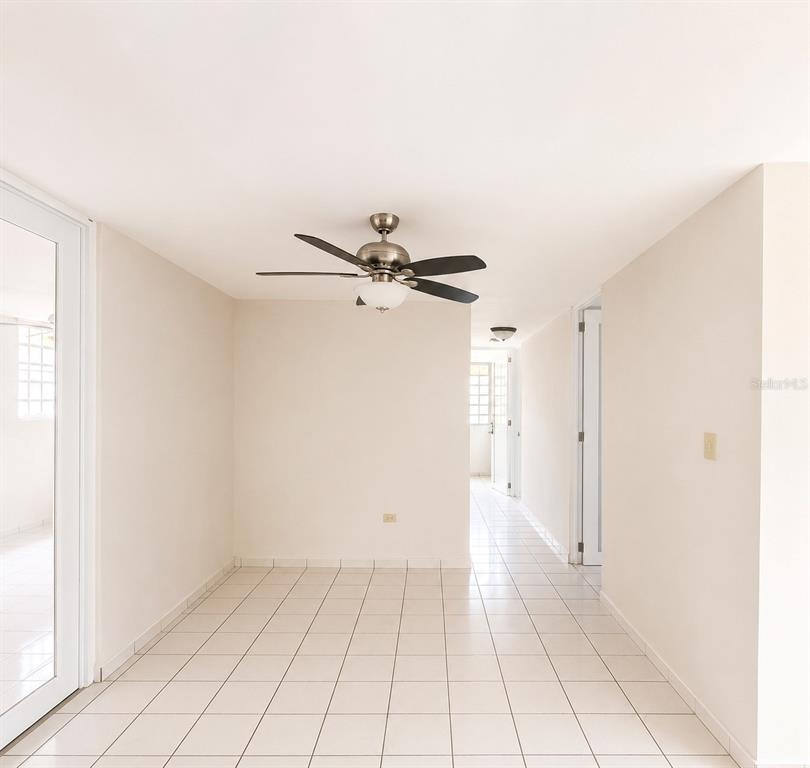 A room with white tile floors, a ceiling fan, and a hallway leading to another room — 518 CALLE WITO MORALES ESTANCIAS DEL GOLF CLUB, PONCE, PR