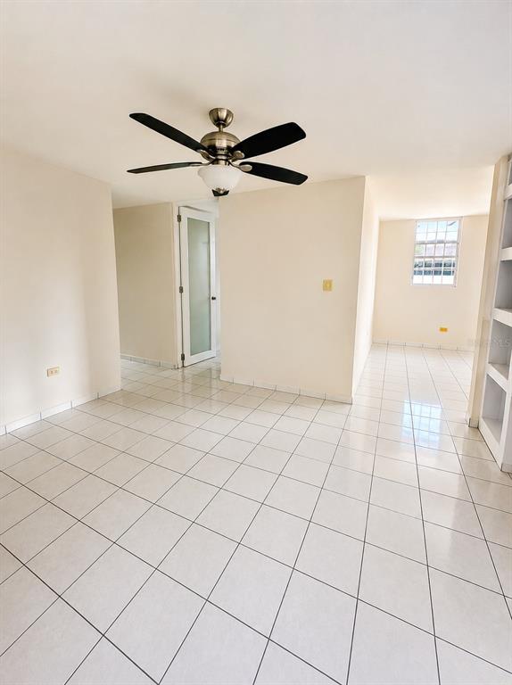 A bright room with white tile floors, a ceiling fan, and a glass-paneled door — 518 CALLE WITO MORALES ESTANCIAS DEL GOLF CLUB, PONCE, PR