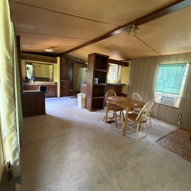 A dining area with a wooden table, chairs, and a stone fireplace in a room — 45600 PANTHER STREET, PAISLEY, FL