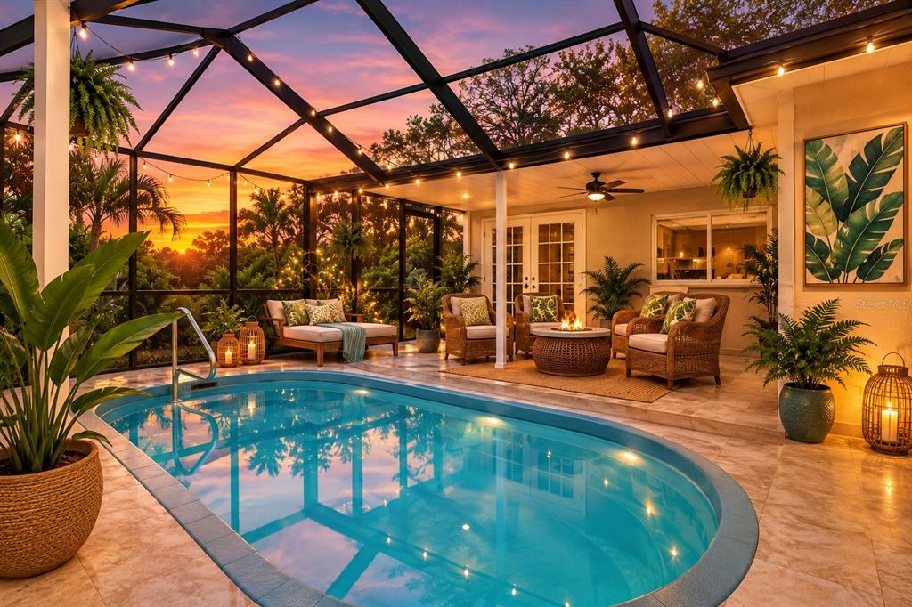 A screened-in patio features a small oval swimming pool, potted plants, and outdoor wicker furniture — 3349 OVERLAND DRIVE, HOLIDAY, FL