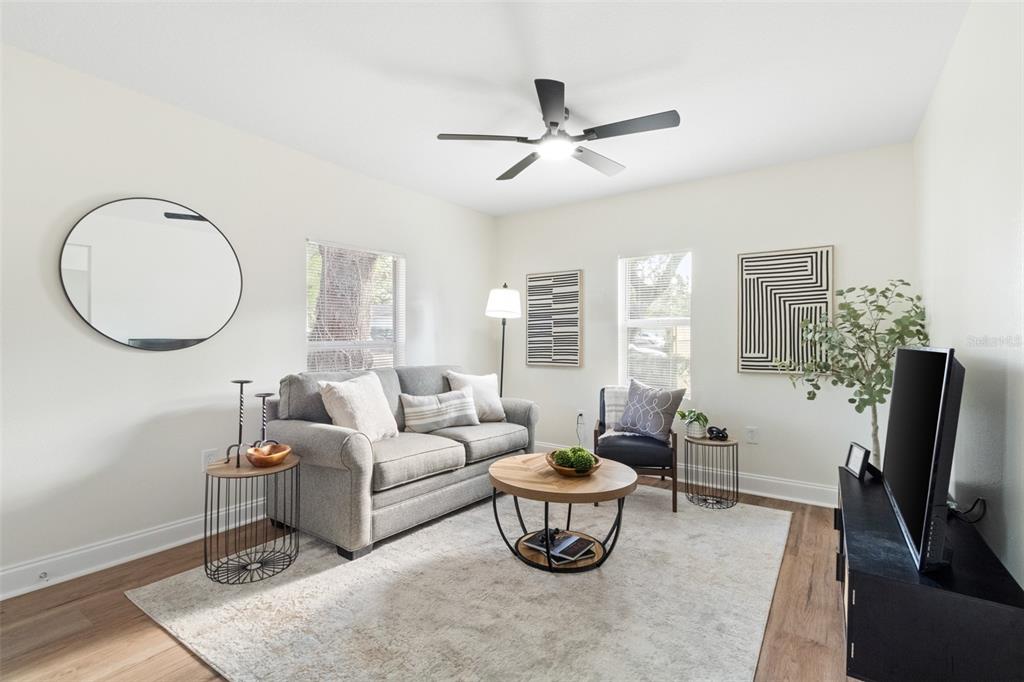 A single-story house with tan siding, a front porch, and a chain-link fence — 2116 E ELLICOTT STREET, TAMPA, FL