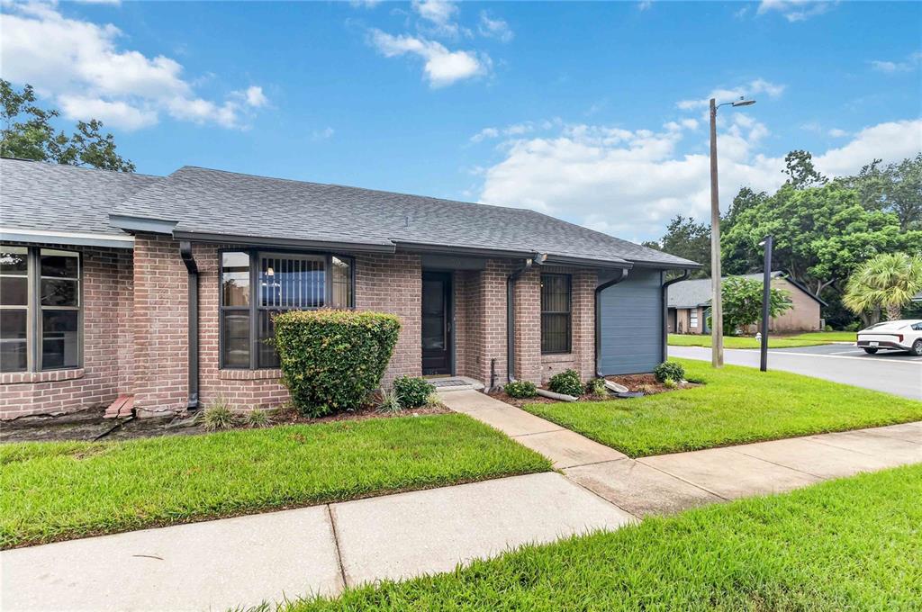 An entryway with a blue door opens into a kitchen with white appliances and cabinets — 2791 KING OAK CIRCLE, ST CLOUD, FL