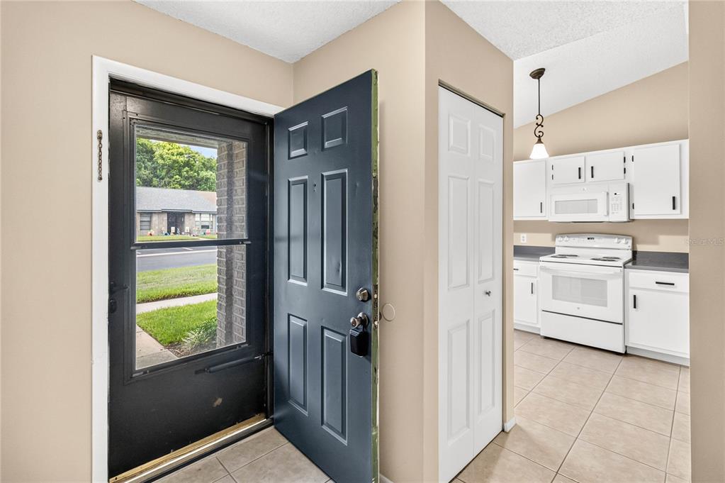 A dining area and living room with beige carpet, a round table, and a sofa — 2791 KING OAK CIRCLE, ST CLOUD, FL