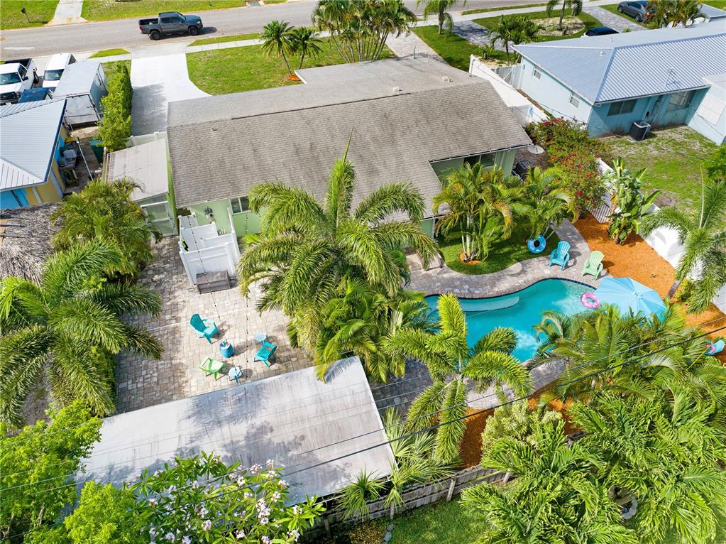 An aerial view of a house with a backyard pool, patio, and several palm trees — 231 OCEAN BOULEVARD, SATELLITE BEACH, FL