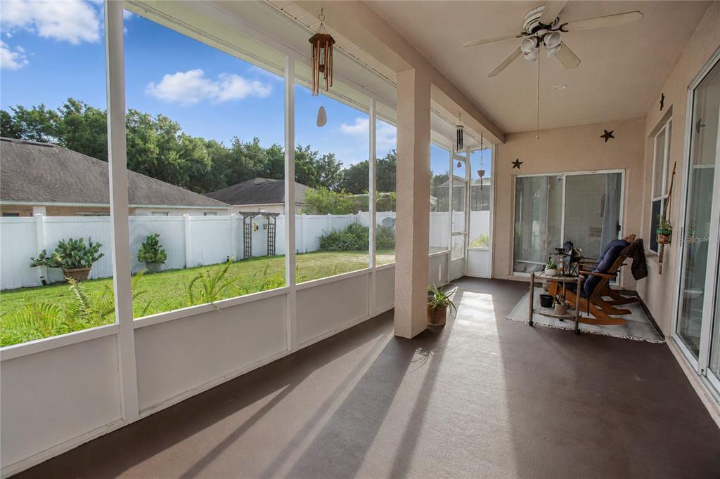 A screened-in patio with a concrete floor, ceiling fan, and a view of the backyard — 3307 ROYAL ASCOT RUN, GOTHA, FL