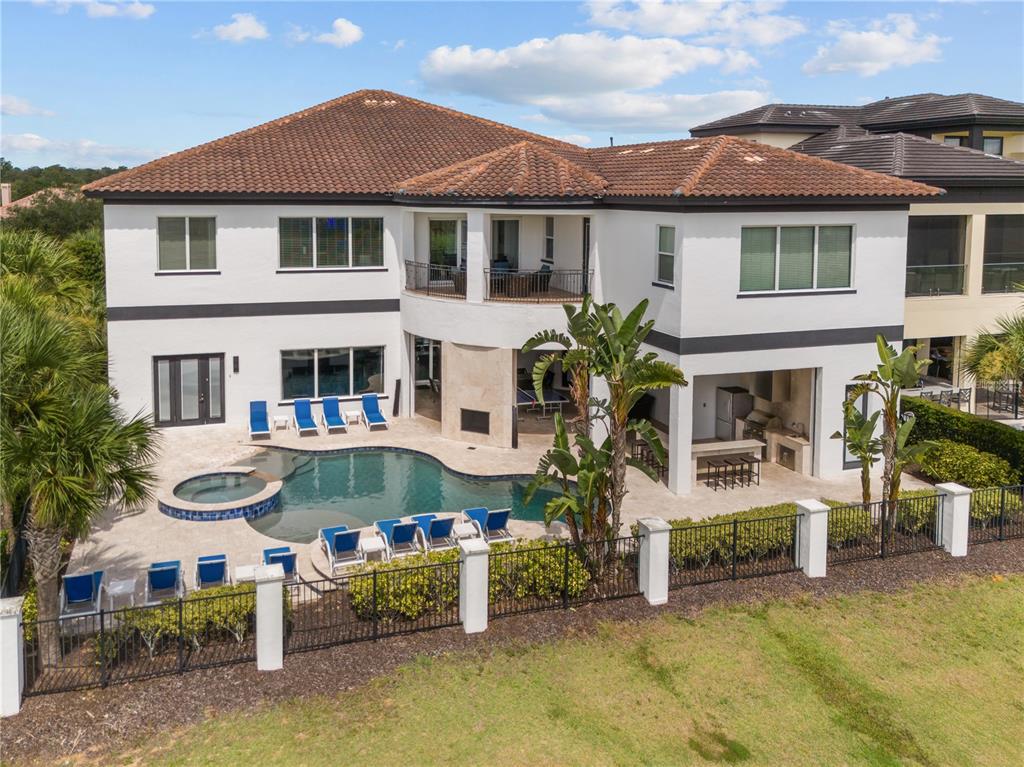 An aerial view of a two-story house with a swimming pool and outdoor kitchen — 1125 GRAND TRAVERSE PARKWAY, REUNION, FL