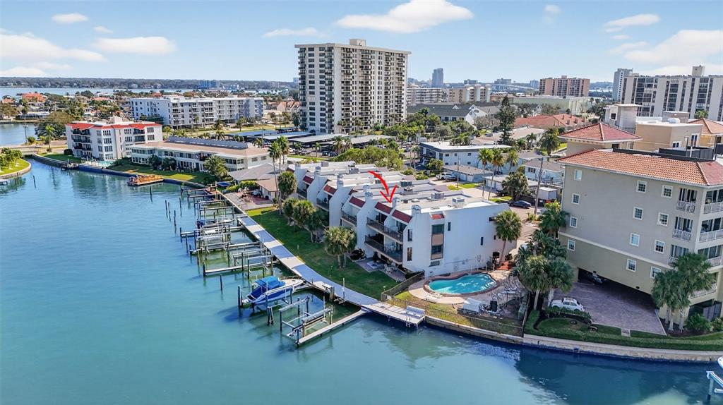 An aerial view of a waterfront condominium complex with boat slips and a swimming pool — 214 SKIFF POINT UNIT 214, CLEARWATER, FL