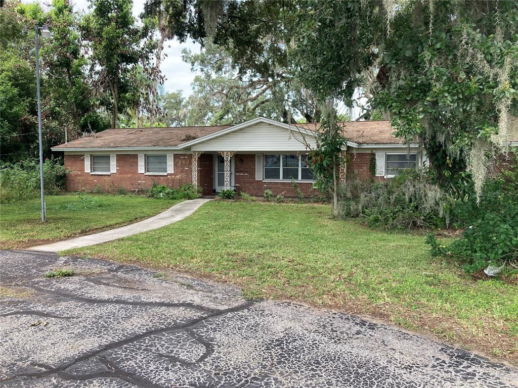 A single-story brick house with a white gable roof and a concrete walkway — 2629 S PARSONS AVENUE, SEFFNER, FL