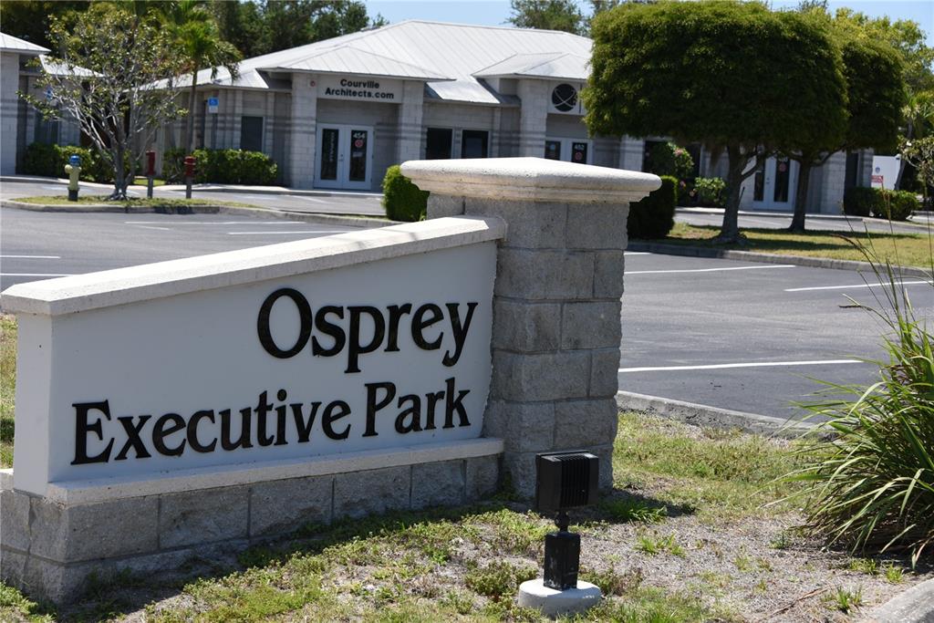 A stone monument sign for Osprey Executive Park stands in front of a commercial building — 418 S TAMIAMI TRAIL UNIT E3, OSPREY, FL