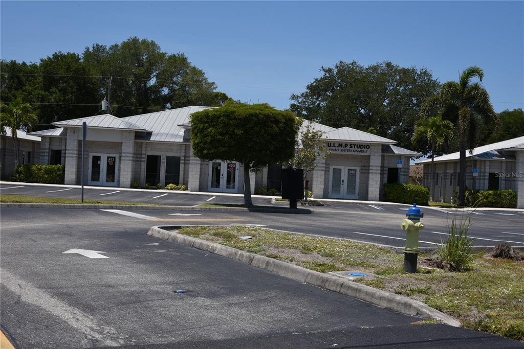 A single-story commercial building with a metal roof and parking lot in front — 418 S TAMIAMI TRAIL UNIT E3, OSPREY, FL