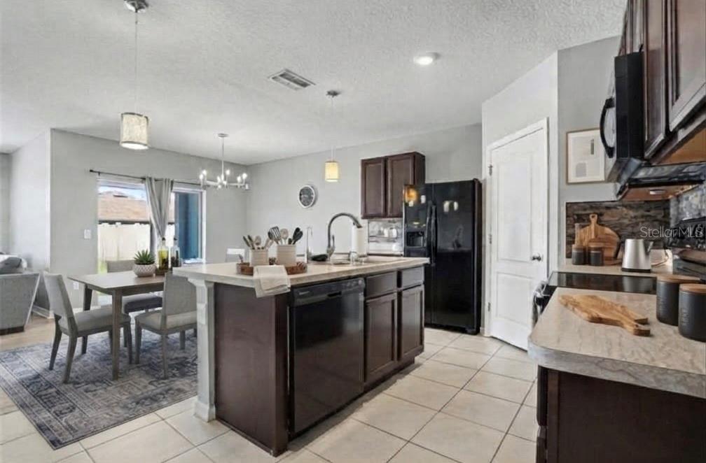 A tiled entryway leads to a carpeted room and a white front door with a transom — 911 WATERVILLE DR, AUBURNDALE, FL