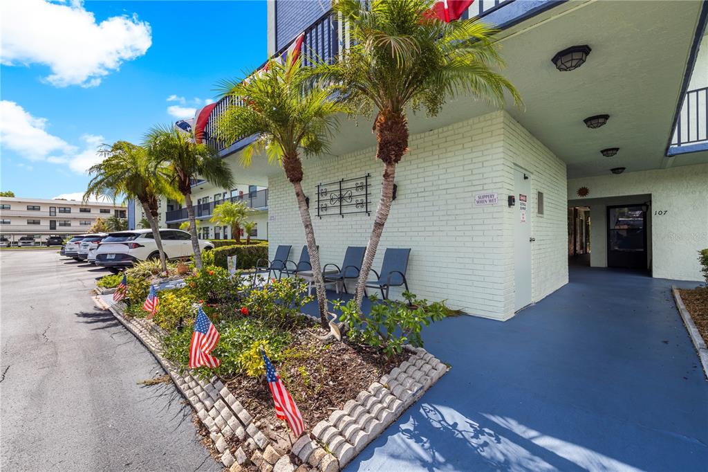 The exterior entrance of a ground-floor unit features a brown storm door labeled 101 — 5973 TERRACE PARK DRIVE N UNIT 101, ST PETERSBURG, FL