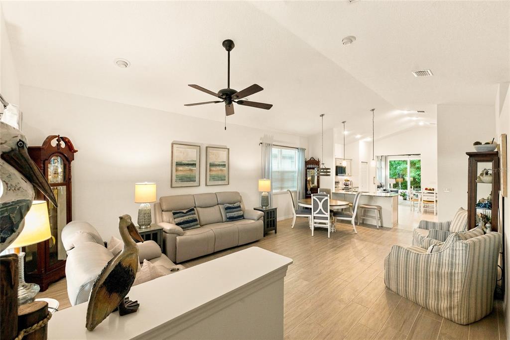An open-concept living and dining area features light tile flooring and a ceiling fan — 91 PARK PLACE CIRCLE, PALM COAST, FL