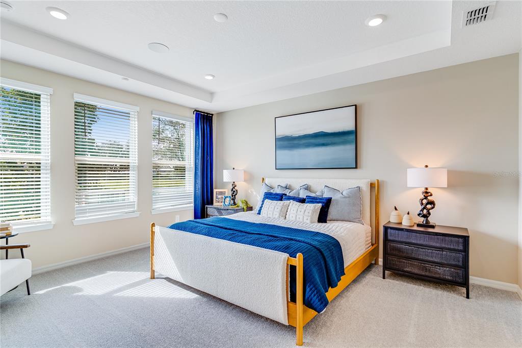 A stainless steel double wall oven is centered between white cabinets and a marble backsplash — 1224 TEAL CREEK DRIVE, ST CLOUD, FL