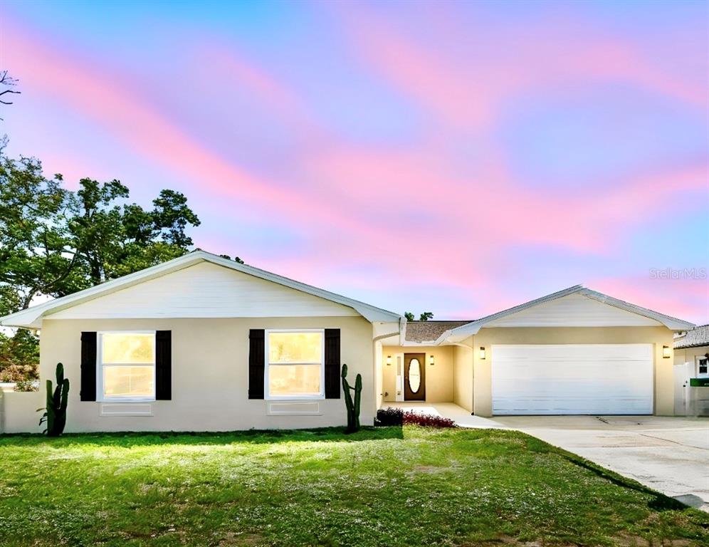 An aerial view shows a house with a brown roof, a pool cage, and a driveway — 2959 MAPLE COURT, DUNEDIN, FL