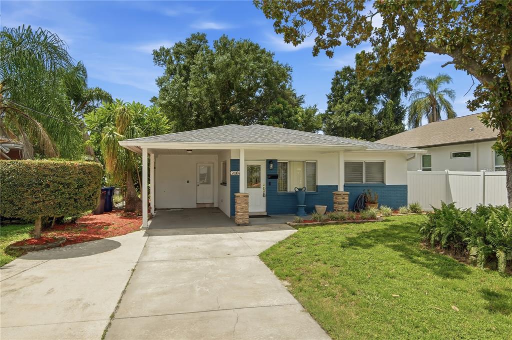 A single-story house with a blue and white exterior, a carport, and a concrete driveway — 3106 W BRADDOCK STREET, TAMPA, FL