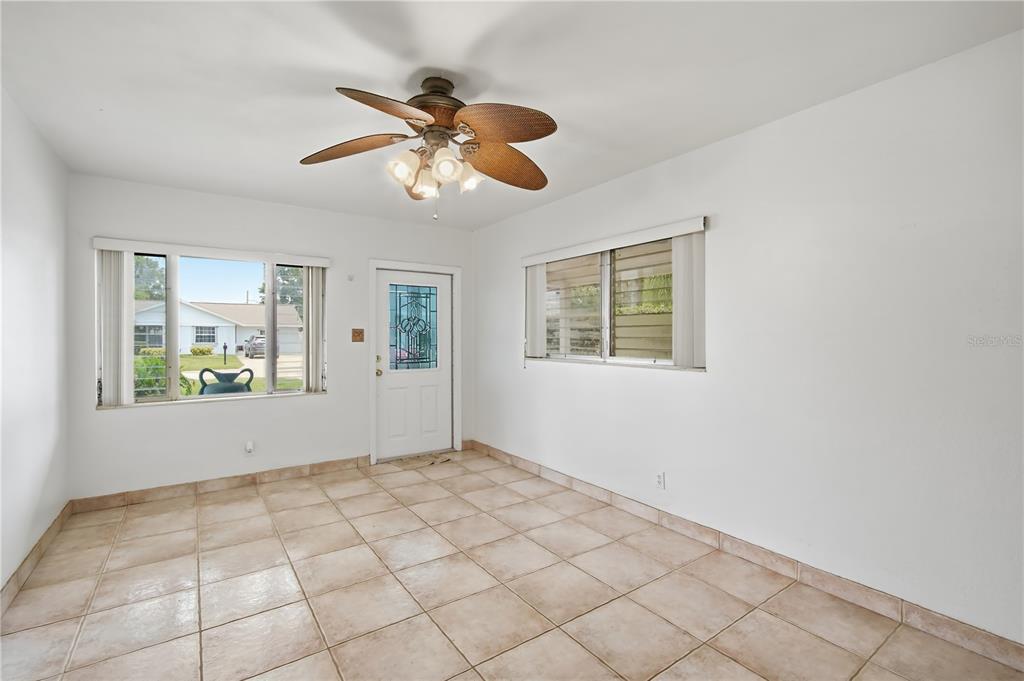 A room with white walls, tile flooring, a ceiling fan, and two windows — 3106 W BRADDOCK STREET, TAMPA, FL