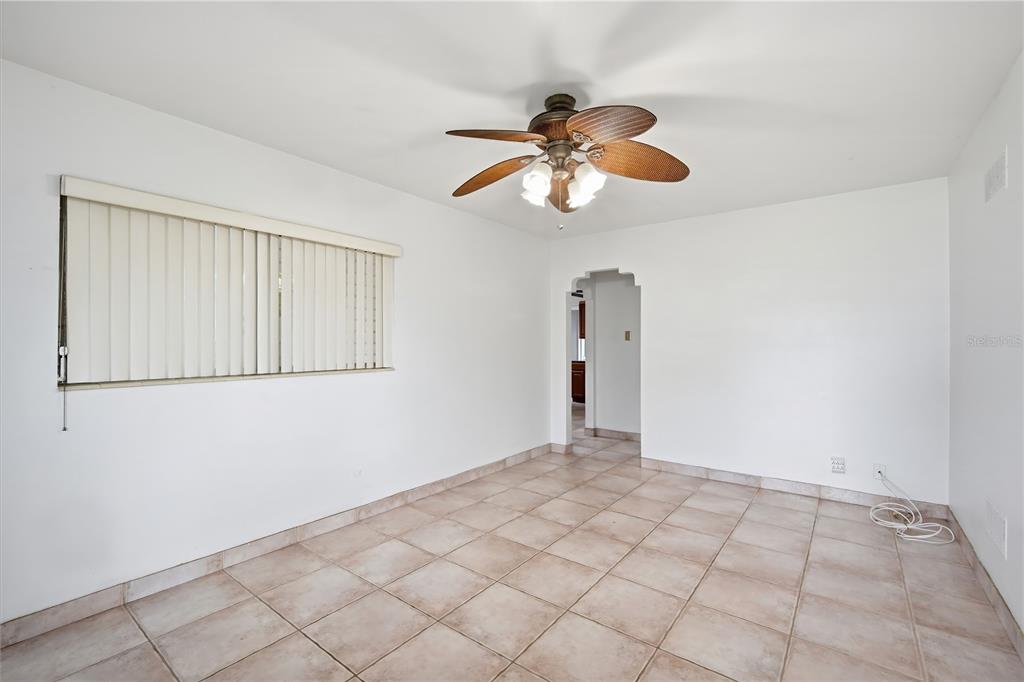 A room with white walls, tile flooring, a ceiling fan, and a window with blinds — 3106 W BRADDOCK STREET, TAMPA, FL