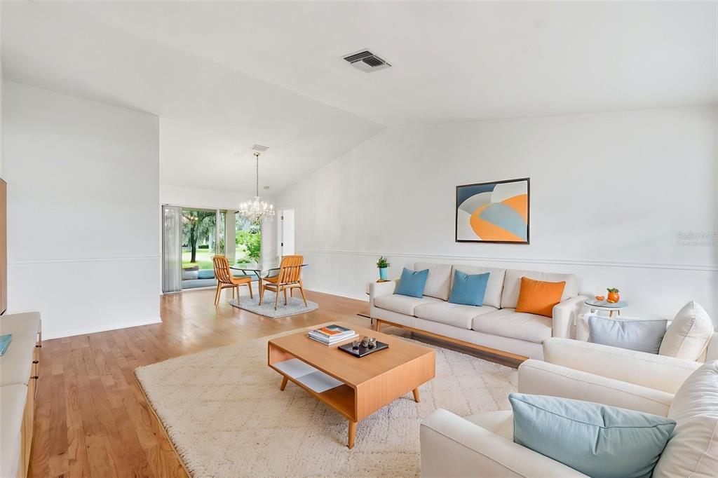 A kitchen with oak cabinets, white appliances, tile flooring, and a view of the outdoors — 1444 CANBERLEY COURT, TRINITY, FL