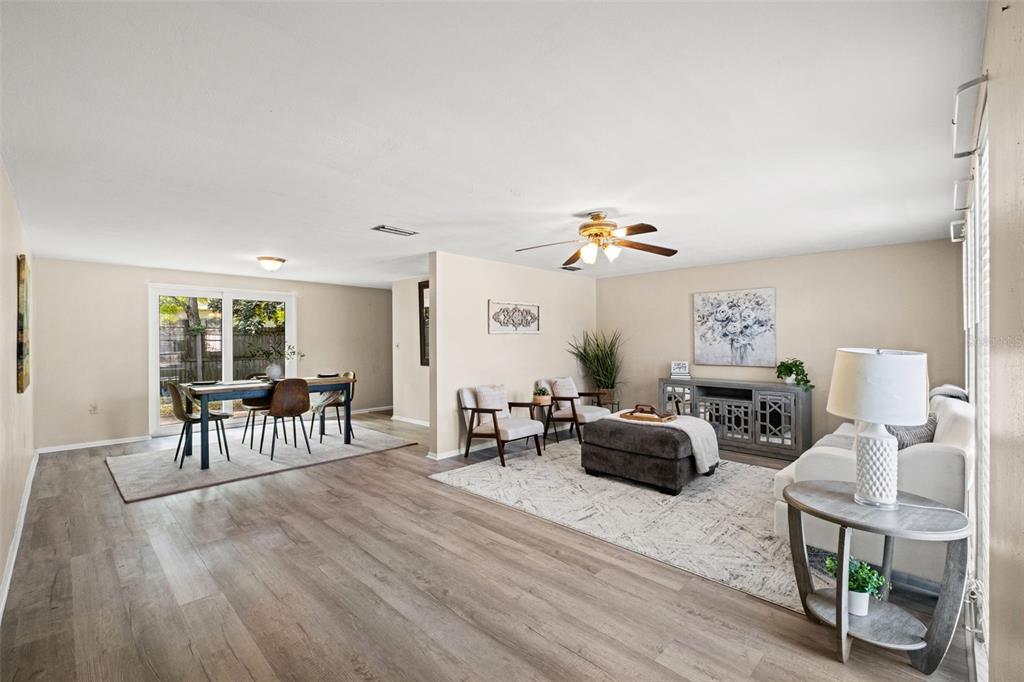 An entryway features light wood-look flooring, a white door, a shoe rack, and a welcome sign — 7710 BIRCHWOOD DRIVE, PORT RICHEY, FL