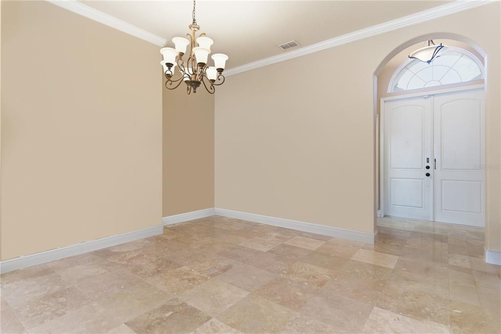 A view from a hallway into a living room with tile floors and tray ceilings — 8875 SW 73RD LANE, GAINESVILLE, FL