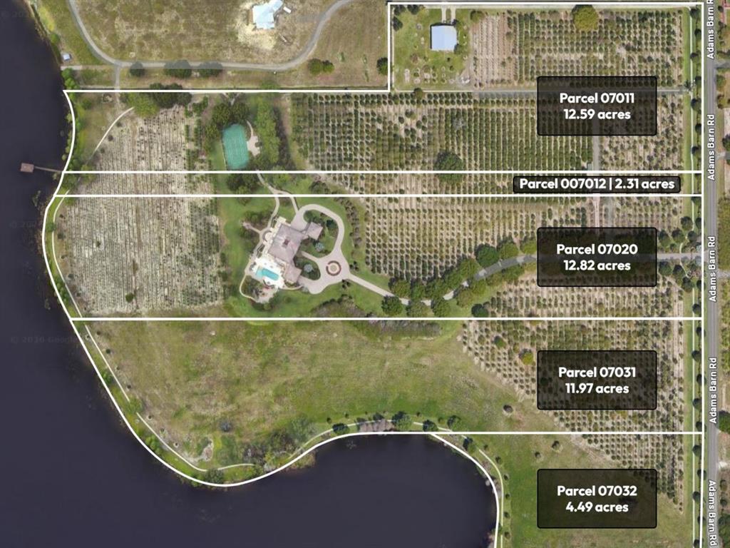 An aerial view shows a large property with palm tree groves, fields, and a lake — ADAMS BARN ROAD, AUBURNDALE, FL