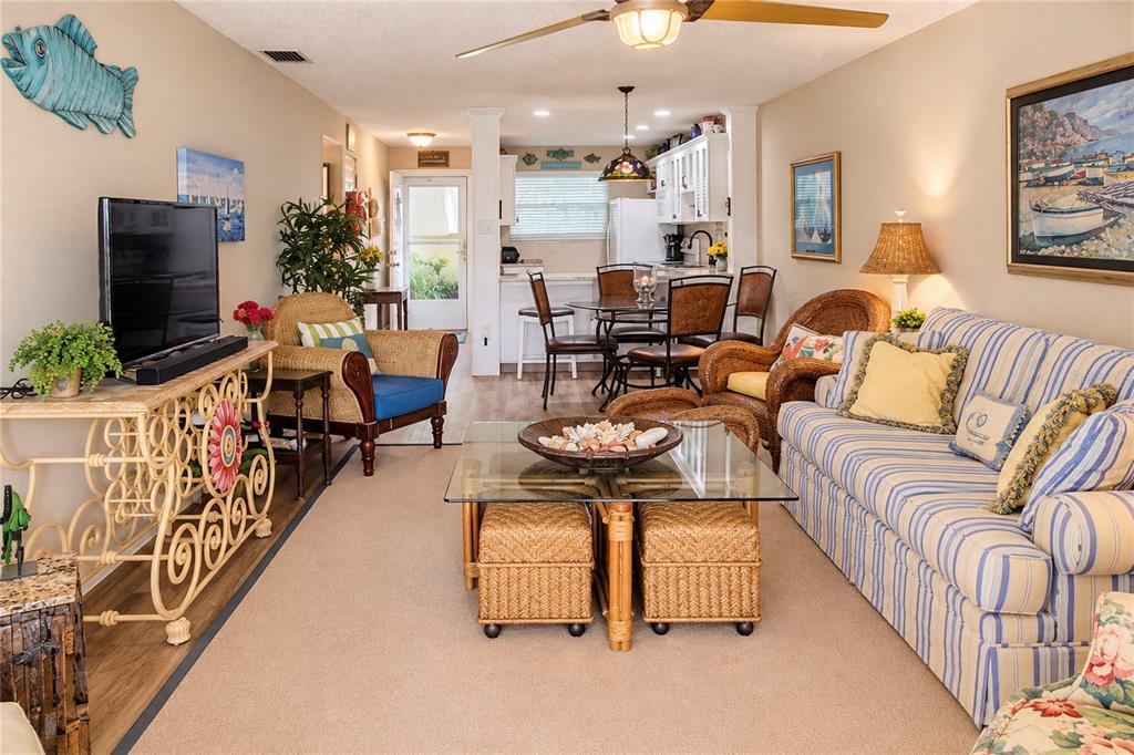 A wooden dock extends toward a multi-story yellow building with boats moored on both sides — 1351 BAYSHORE DRIVE UNIT 108, FORT PIERCE, FL