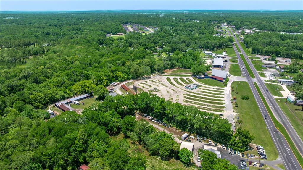 An aerial view shows a drive-in theater with parking rows next to a highway — 4850 S PINE AVENUE, OCALA, FL