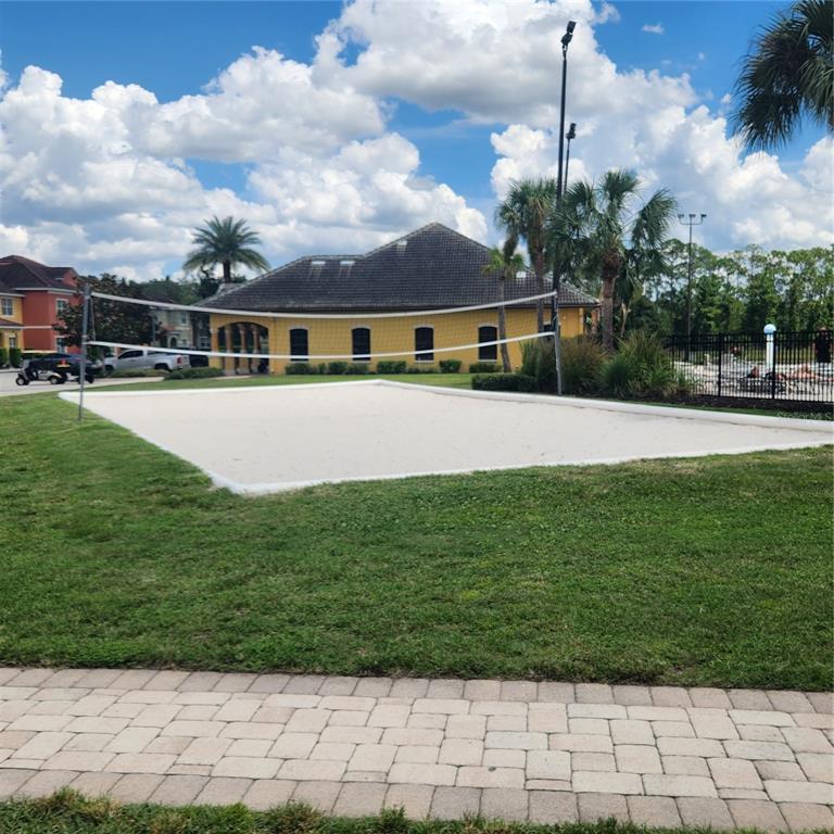A dining area with a wooden table and chairs sits adjacent to a living room — 8935 CUBAN PALM ROAD, KISSIMMEE, FL