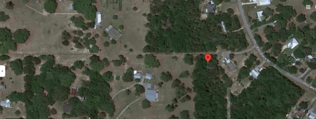 This is an aerial map view showing a vacant lot marked with a red pin — 7058 SEWANEE STREET, KEYSTONE HEIGHTS, FL