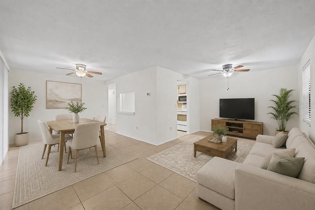 This is a virtual staging of an open-concept living and dining room with tile floors — 123 LOBLOLLY COURT UNIT A, OLDSMAR, FL