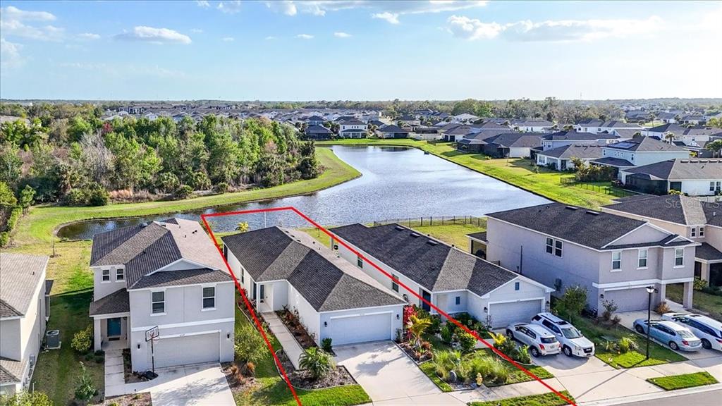 An aerial view shows a single-story house with a red outline bordering its property line — 6333 MILESTONE LOOP, PALMETTO, FL