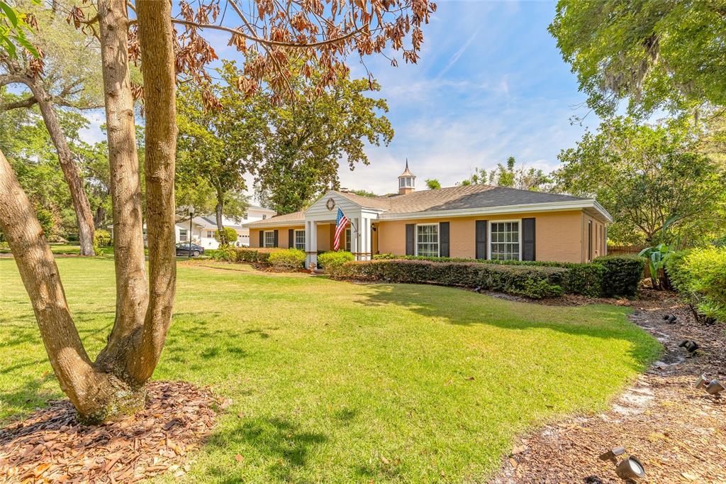 A single-story tan brick house with a white columned entrance and a cupola roof — 1600 S PENNSYLVANIA AVENUE, WINTER PARK, FL