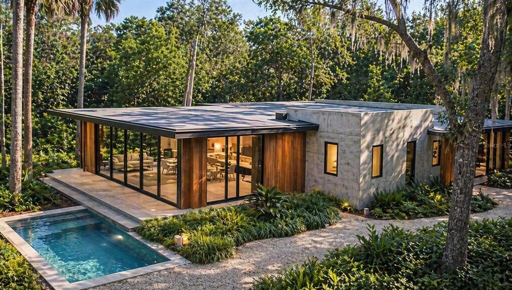 A modern house with concrete walls, wood paneling, and floor-to-ceiling windows overlooks a swimming pool — 936 PARADISE BOULEVARD, GEORGETOWN, FL