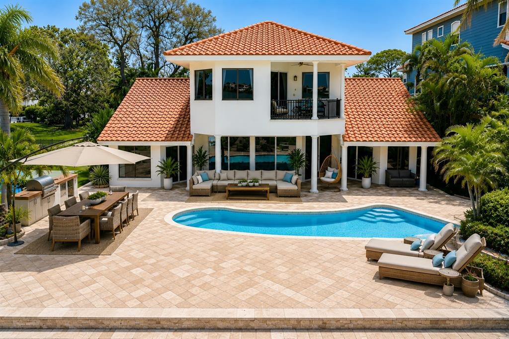 A paved driveway leads to the entrance of a two-story building with a tiled roof — 1632 SEA BREEZE DRIVE, TARPON SPRINGS, FL