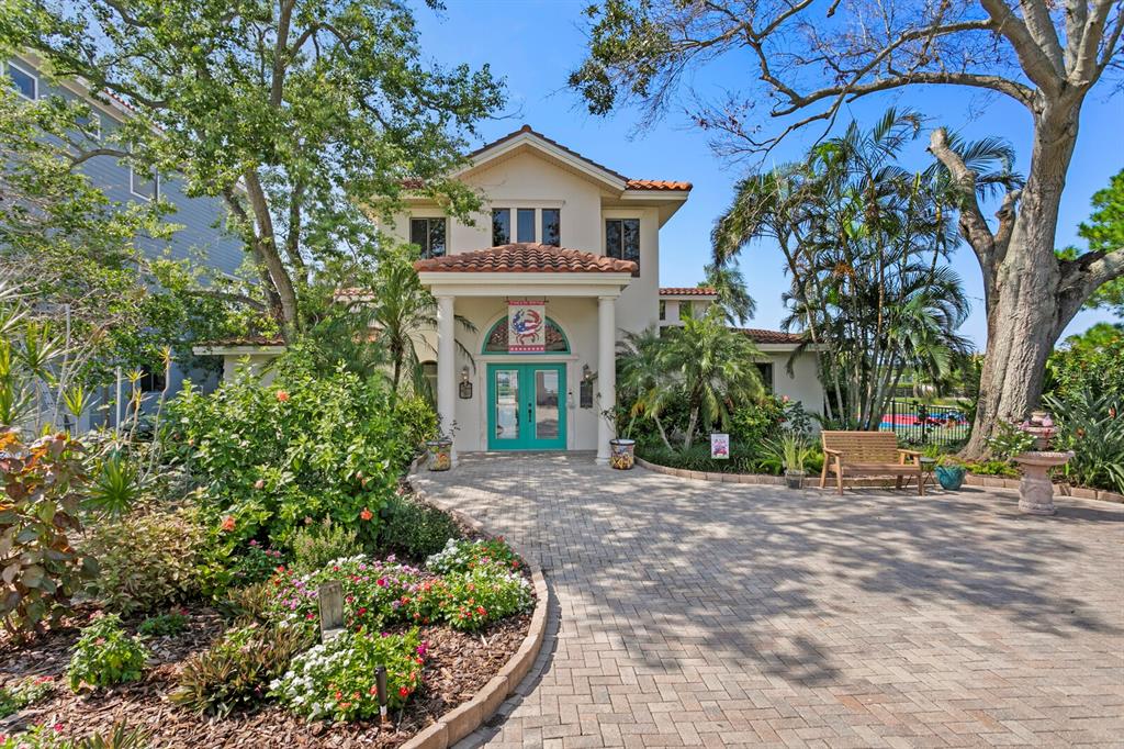 An aerial view shows waterfront houses with private docks and swimming pools along a bay — 1632 SEA BREEZE DRIVE, TARPON SPRINGS, FL