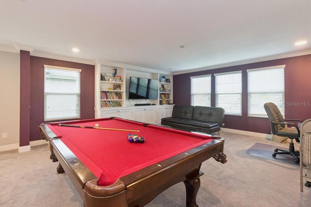 A two-story house with a stone-accented facade, a two-car garage, and a paved driveway — 19129 LONG LAKE RANCH BOULEVARD, LUTZ, FL