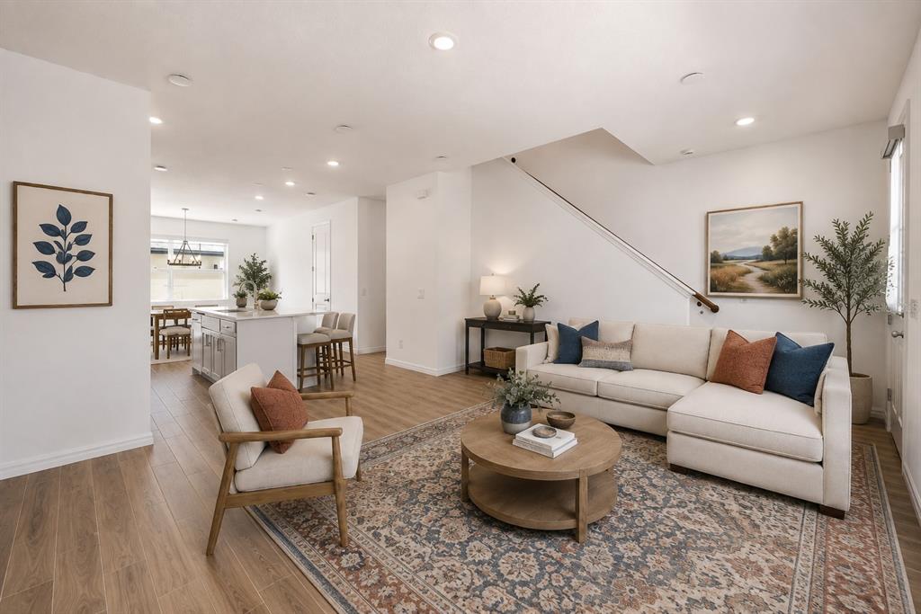 An empty room with white walls, light wood-look flooring, a window, and a white door — 17723 JAPONICA BLOOM DRIVE, WINTER GARDEN, FL