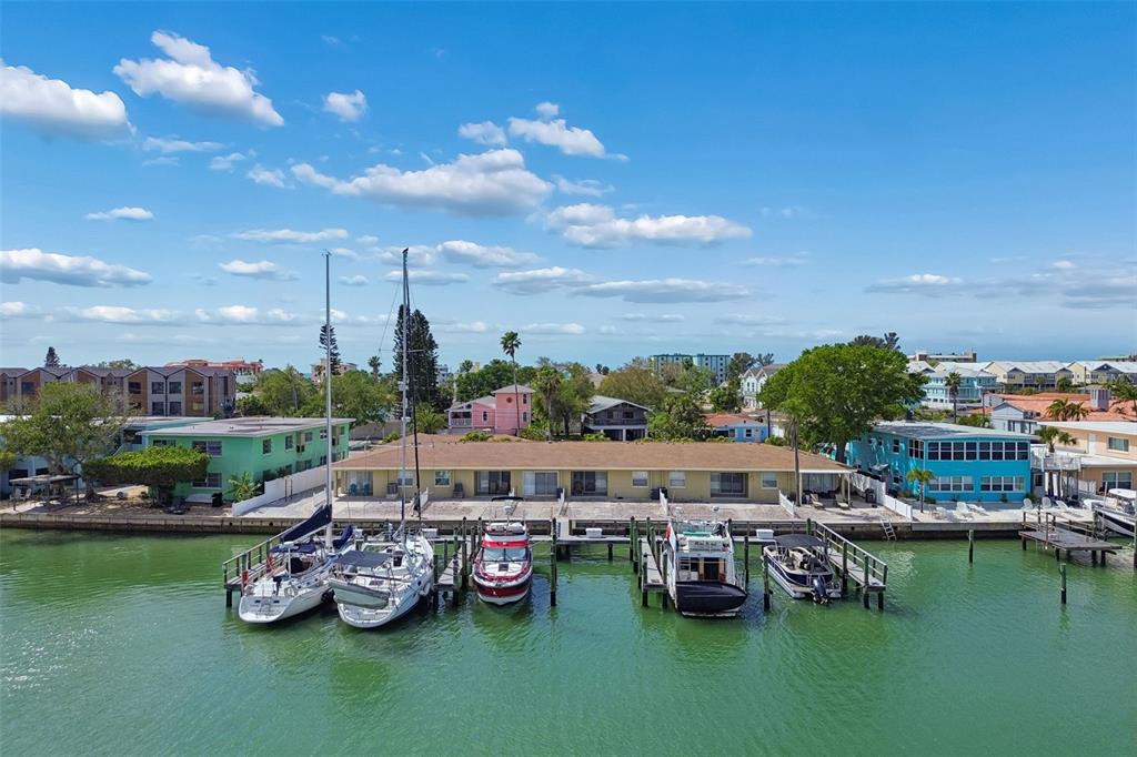 An aerial view shows a waterfront apartment building with several boats docked at the piers — 2307 BAY BOULEVARD, INDIAN ROCKS BEACH, FL