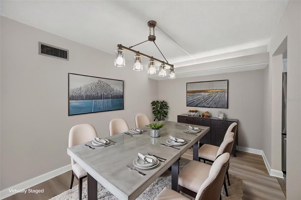 A multi-story apartment building with a circular driveway, palm trees, and a central entrance canopy — 4780 COVE CIRCLE STREET UNIT 103, ST PETERSBURG, FL