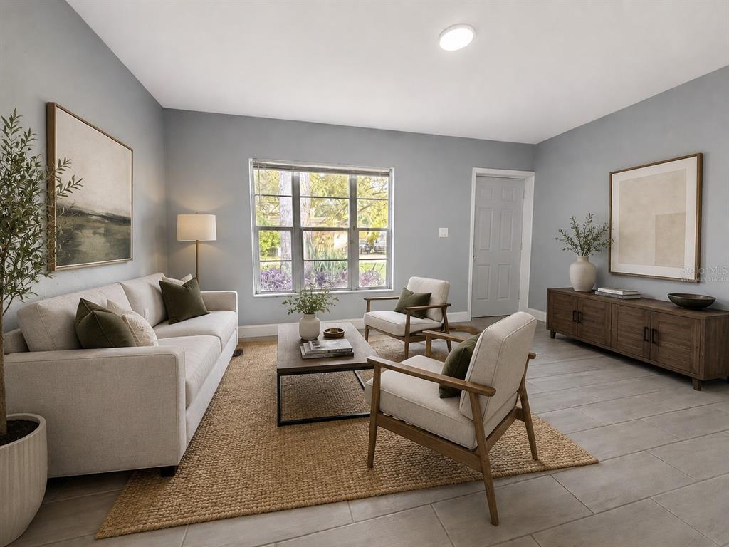 A living room features light gray walls, tile flooring, a beige sofa, and two armchairs — 6007 CORSON AVENUE, NEW PORT RICHEY, FL