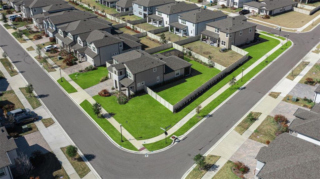 An aerial view shows a corner lot with a two-story house and a fenced yard — 33287 SYCAMORE LEAF DRIVE, WESLEY CHAPEL, FL