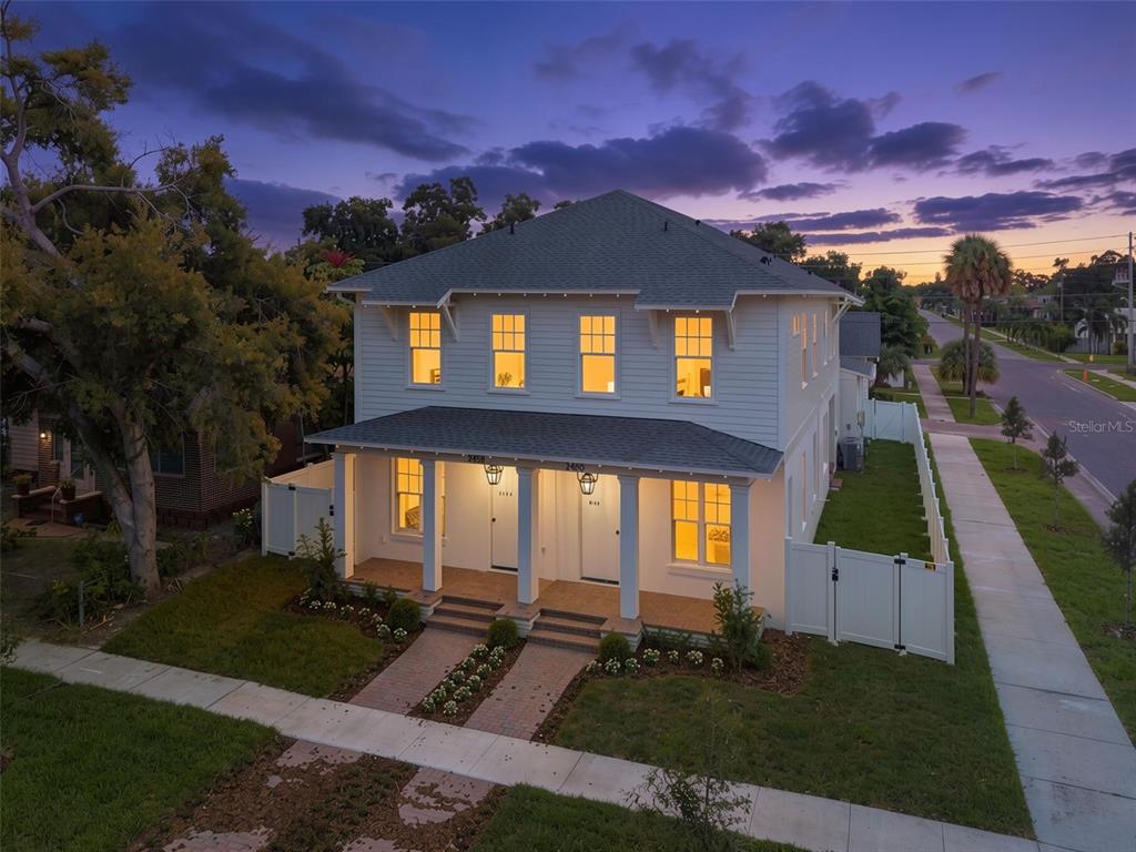 A two-story duplex with white siding, a front porch, and brick steps under construction — 2460 1ST AVENUE S, ST PETERSBURG, FL