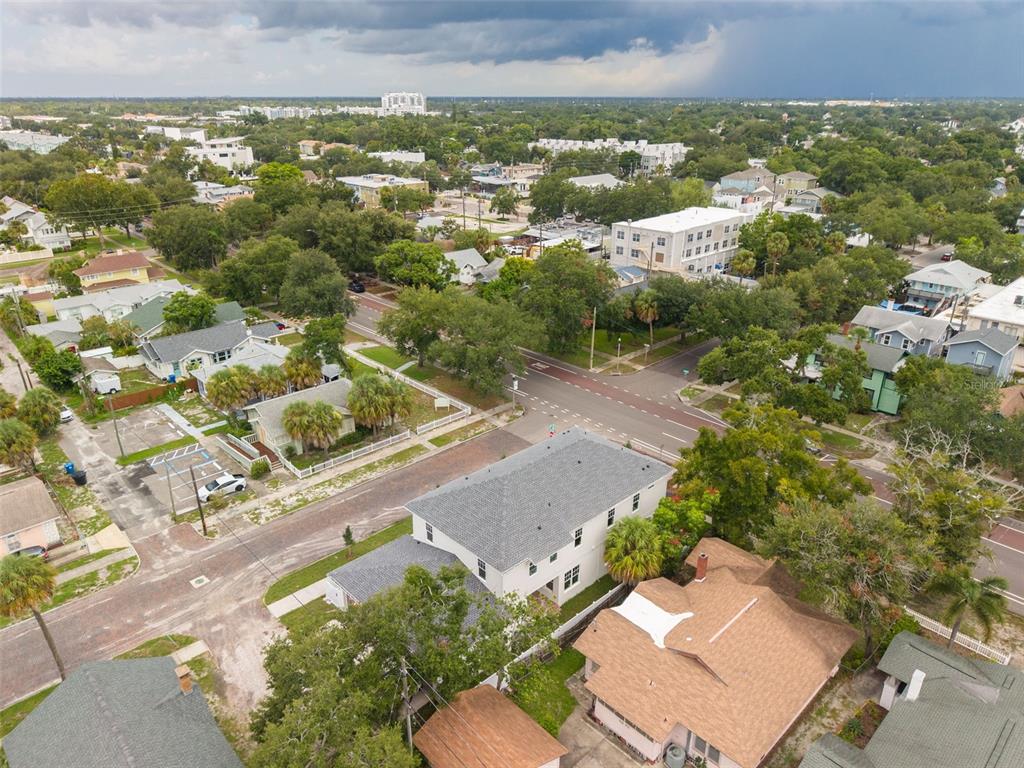 A two-story house with an open-air two-car garage and unfinished dirt ground — 2460 1ST AVENUE S, ST PETERSBURG, FL