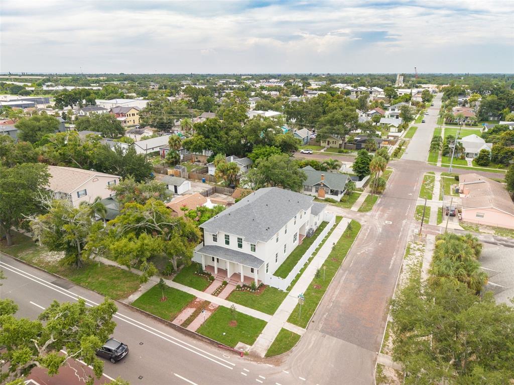 An aerial view of a newly constructed two-story duplex on a corner lot — 2460 1ST AVENUE S, ST PETERSBURG, FL