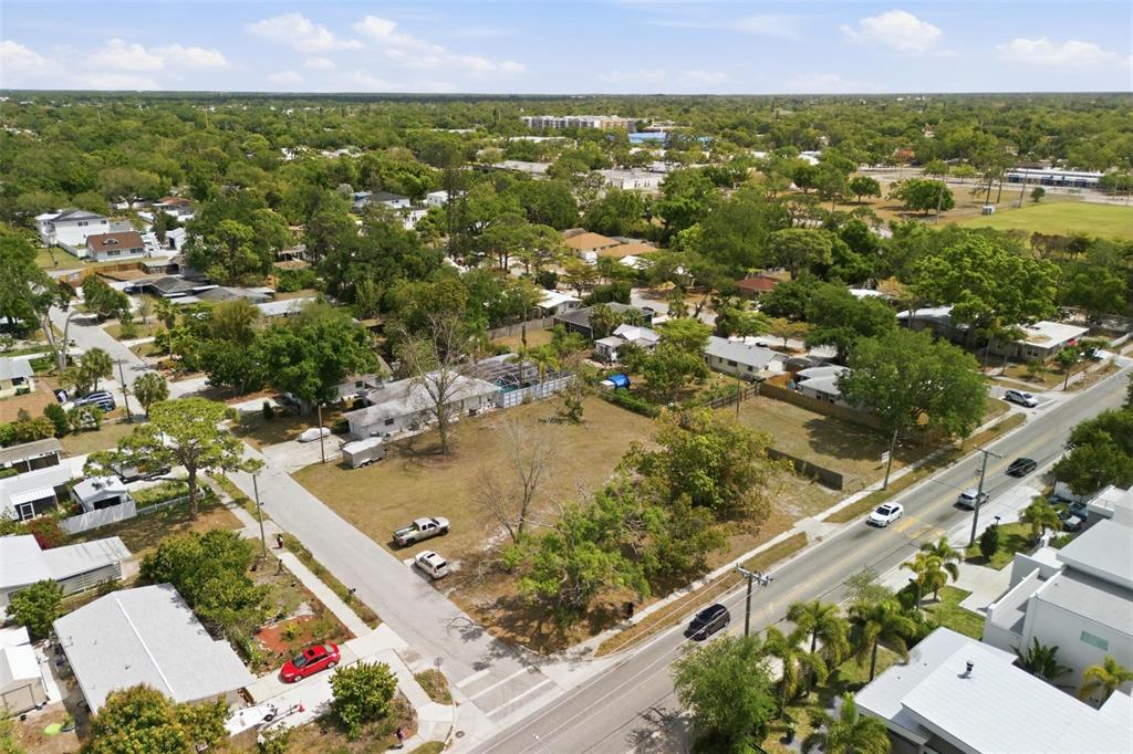 An aerial view shows a vacant residential lot situated between houses and a paved road — 0 BAY STREET, SARASOTA, FL